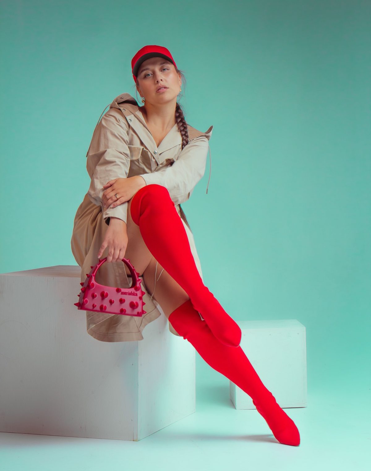 A Utility Jacket with Red Boots for a Playful Color Contrast